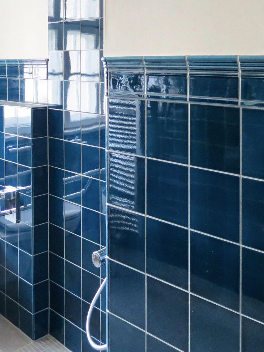 Mittelhoch gefliestes Badezimmer mit blauen Wandfliesen